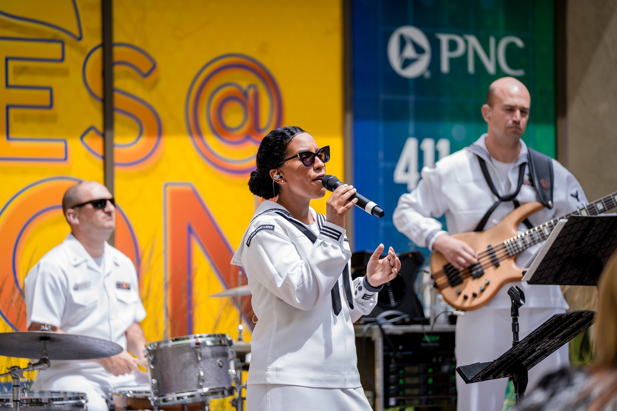 Three members of a band perform at Tunes@Noon.