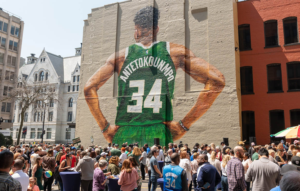 A crowd looks at the Giannis Mural in downtown Milwaukee.