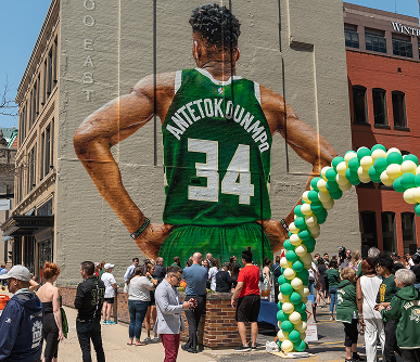 Giannis A group of people stand outside the Giannis mural in Milwaukee.
