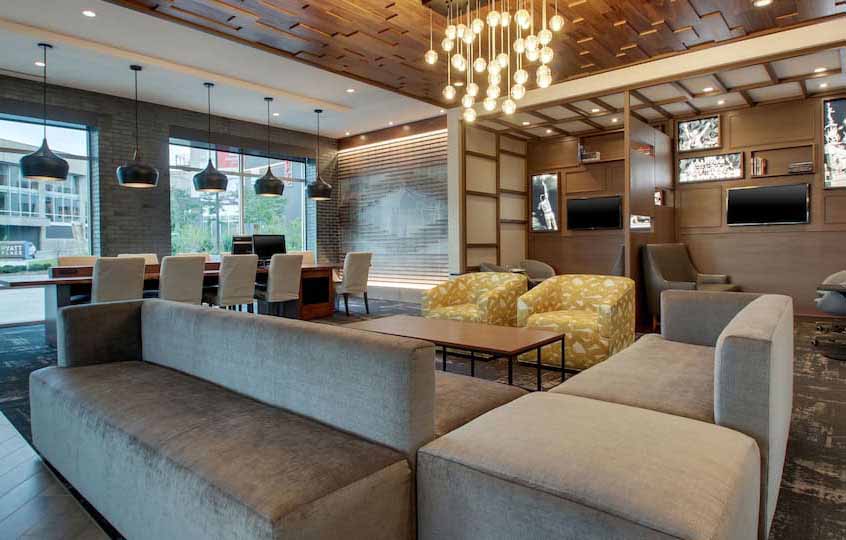 River Bank Plaza The lobby of the Hyatt hotel features couches, a conference table and wood pannelling.