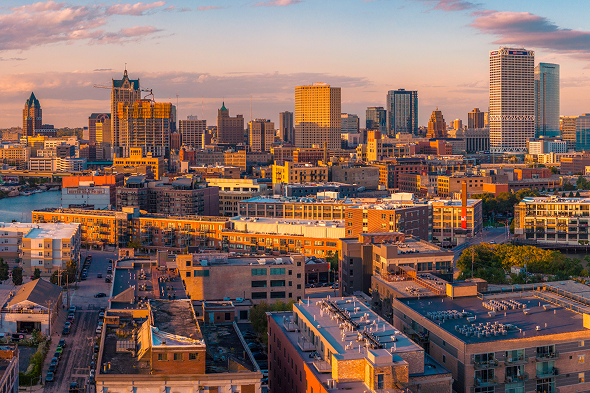 about the bid An aerial view of downtown Milwaukee during golden hour.