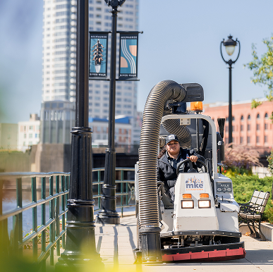 clean sweep A member of the Clean Sweep crew cleans the sidewalk.