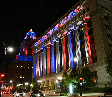 The Northwestern Mutual building's columns lit up in red and blue.