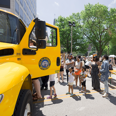 Kids line up to peek inside a Department of Public Works truck at Big Truck Day.