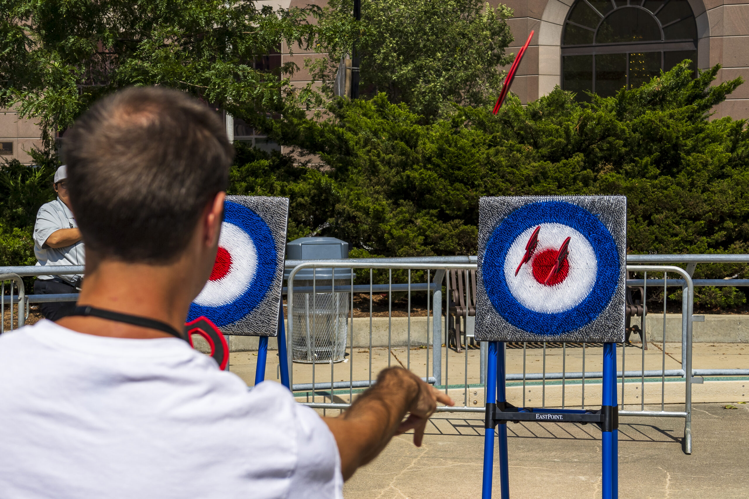 Man playing darts outside