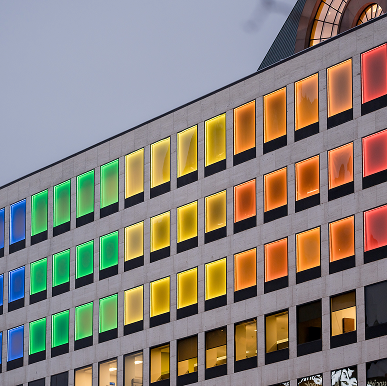 A downtown Milwaukee building is lit up with the colors of the rainbow.