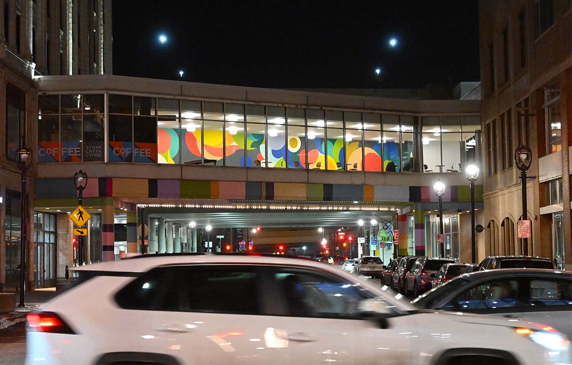 The Skywalk mural at night showcases the vibrant pops of color.