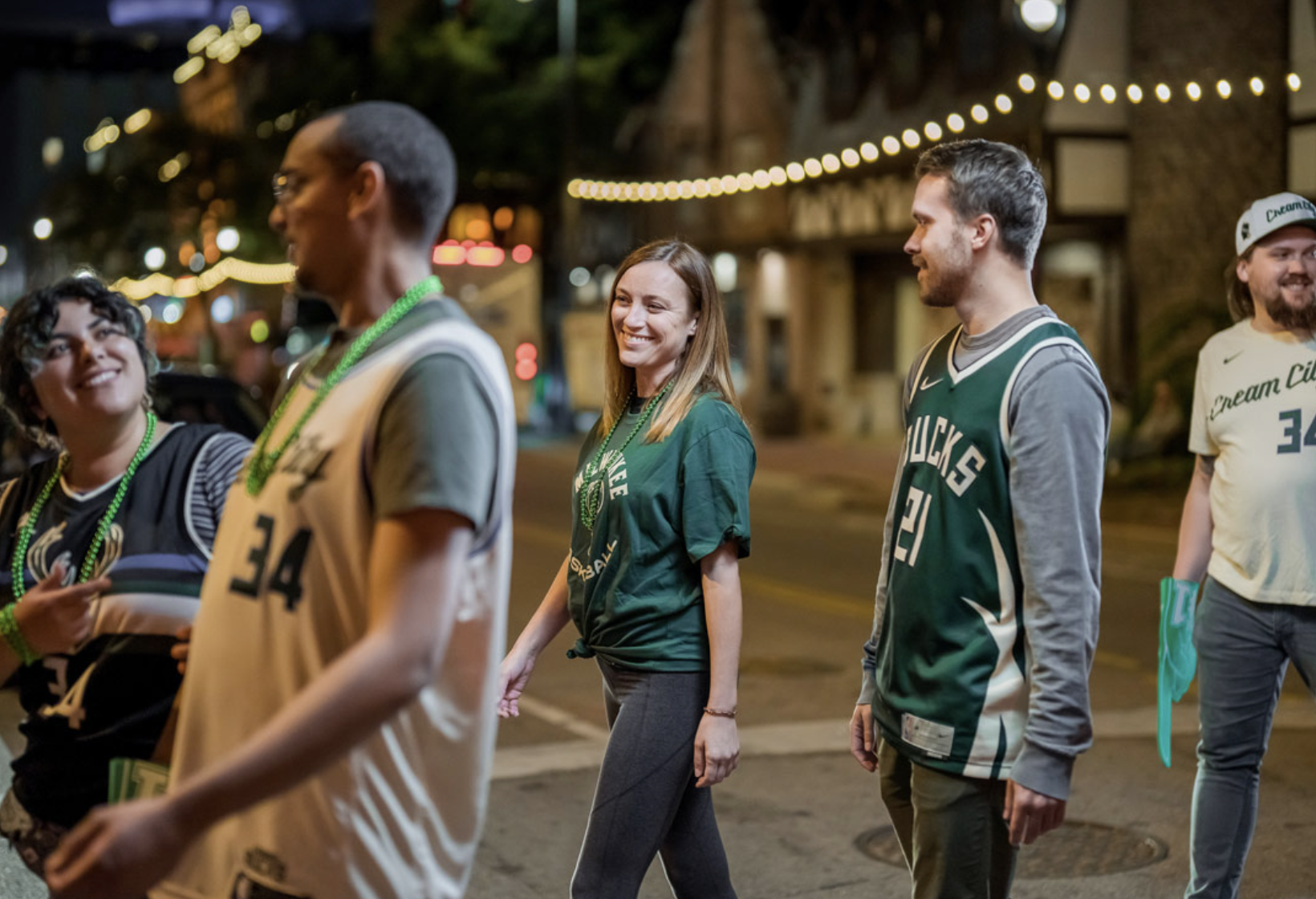 Bucks fans walking A group of Milwaukee Bucks fans crossing the street.