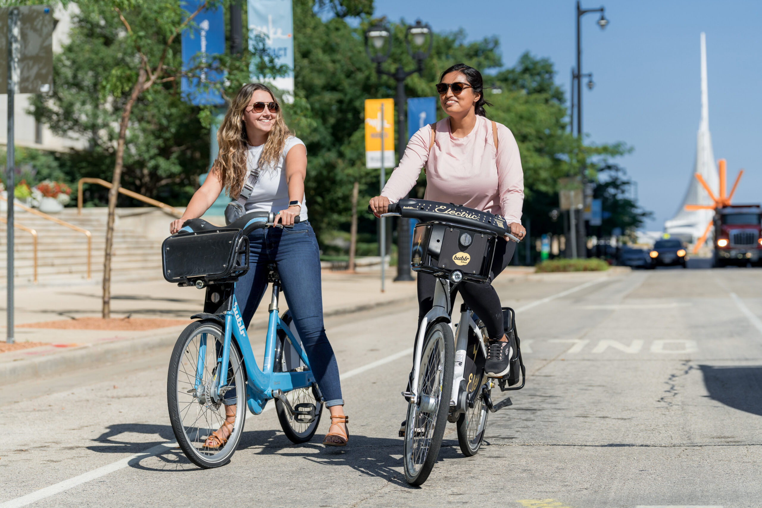 Two women riding Bublr Bikes in Milwaukee.