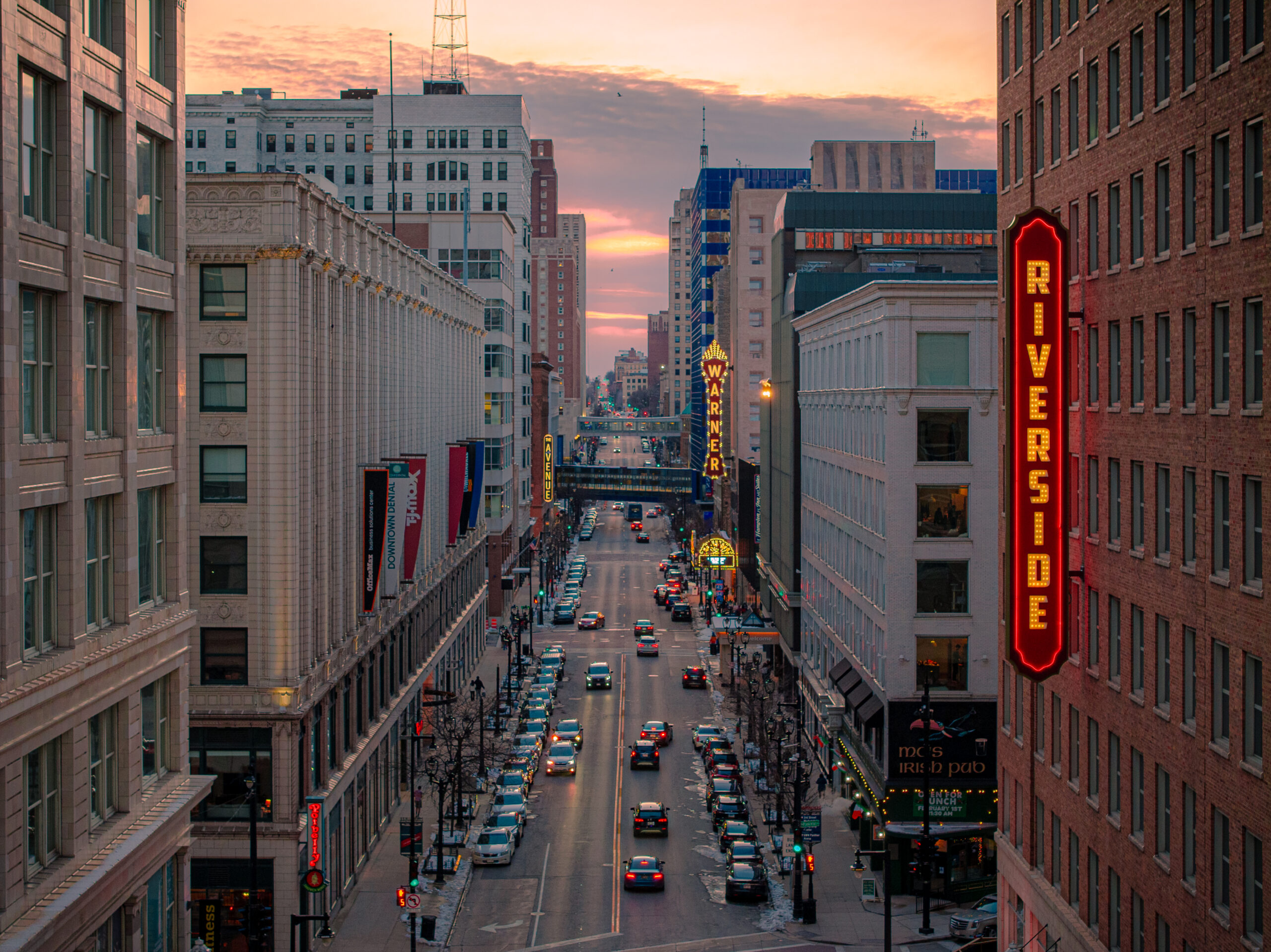 A look downtown Wisconsin Avenue with several theater signs lit up.